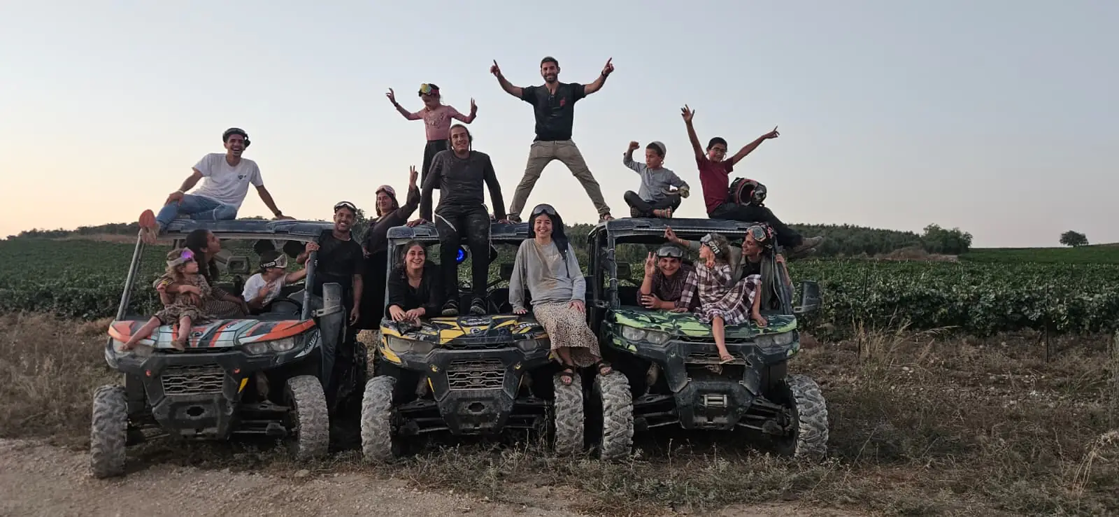 A group parked under pine trees on a ride