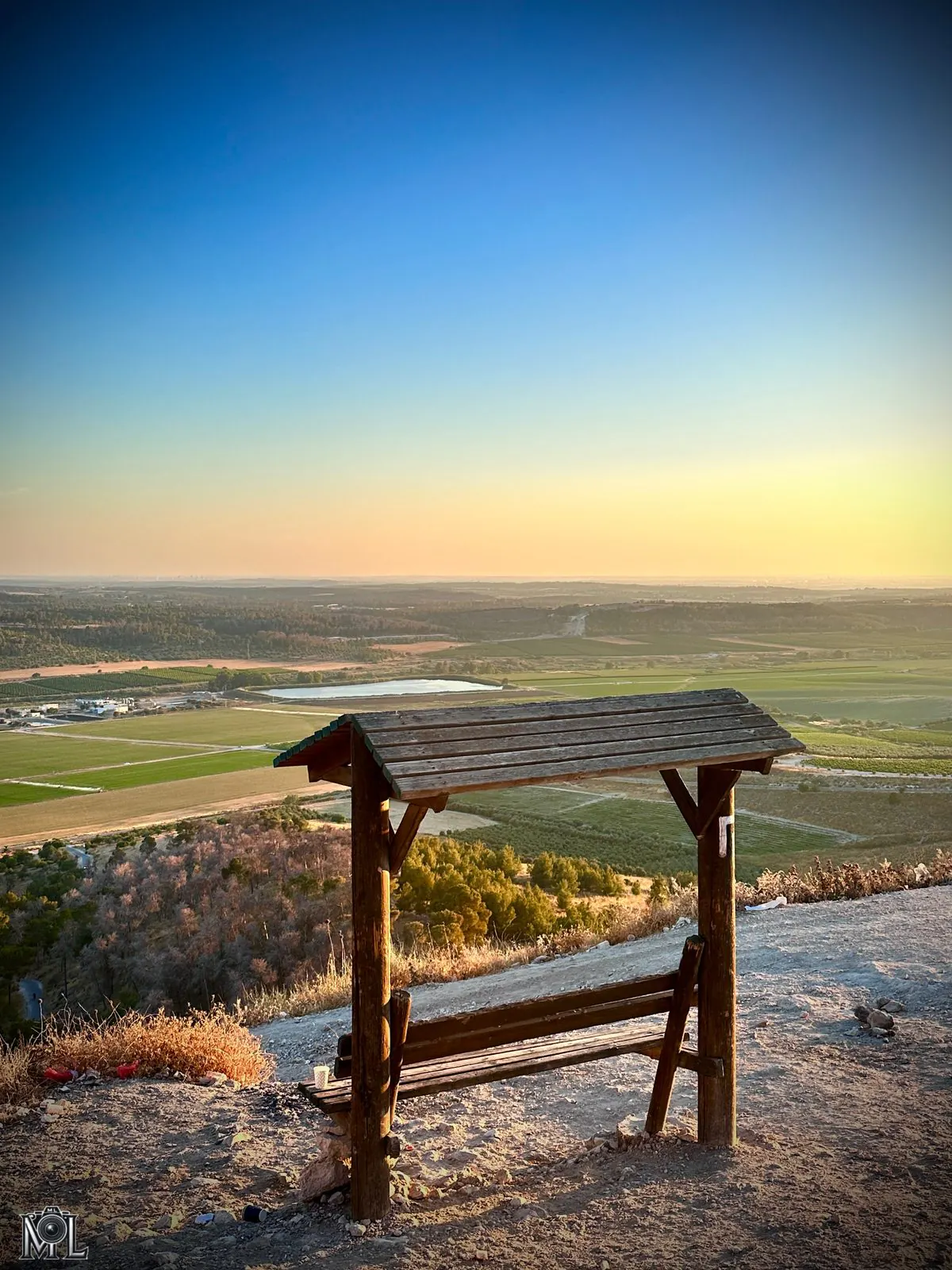 Wooden shelter at a ridge viewpoint over the valley at sunset